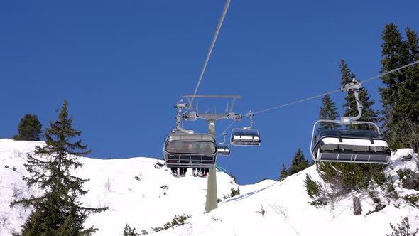 Ski Lift Moving Over Snowy Landscape in Austrian Alps