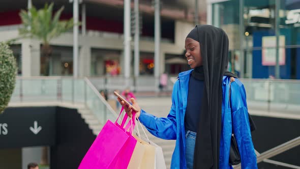 Muslim Shopper Texting on Smartphone