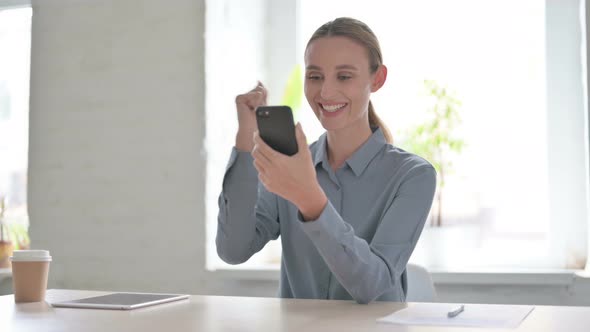 Successful Woman Celebrating on Smartphone