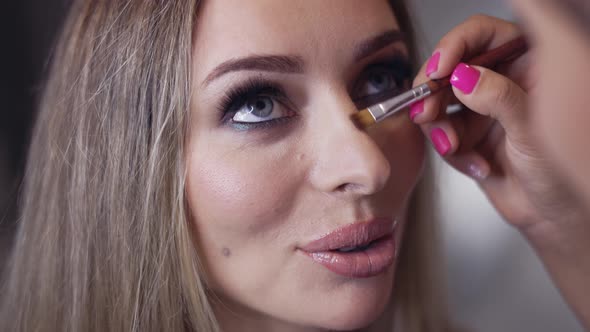 Makeup Artist Contouring Model's Nose Using a Brush