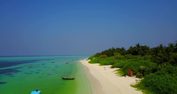 Daytime birds eye abstract shot of a sandy white paradise beach and aqua blue water background in be