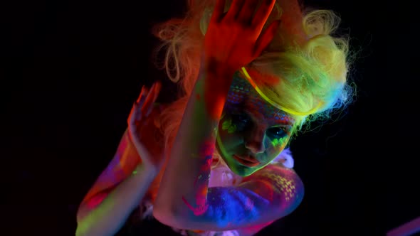 Strange Woman with Fluorescent Makeup on Face and Body Extravagant Hairstyle for Actress