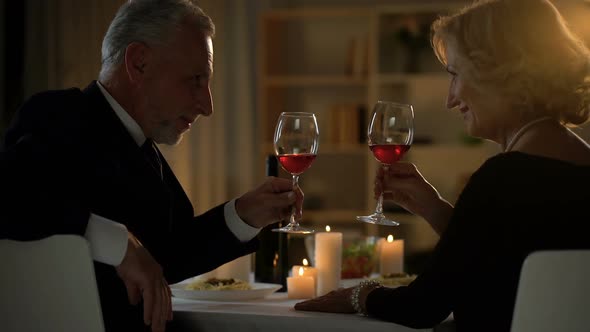 Elegant Adult Couple Drinking Wine and Kissing, Love Togetherness, Soulmates