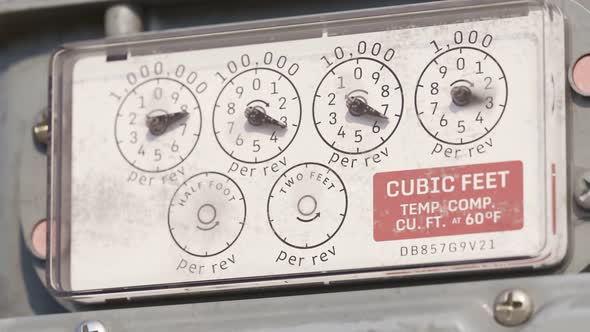 A gas meter gauges in closeup camera. Fast fuel flow shown in a timelapse. 4KHD