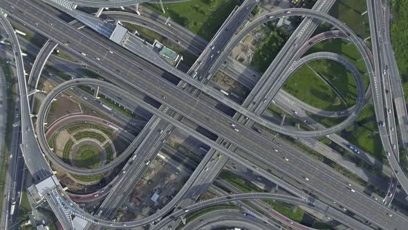 Aerial View of Highway Road Interchange with Busy Urban Traffic Speeding on Road