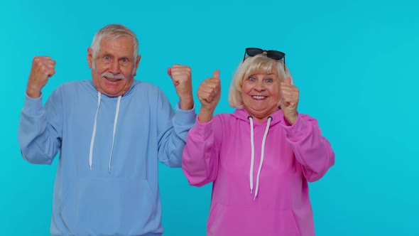 Cheerful Senior Couple Man Woman Grandparents Shouting Celebrating Success Winning Goal Achievemen