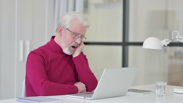 Old Man Taking Nap While Working on Laptop