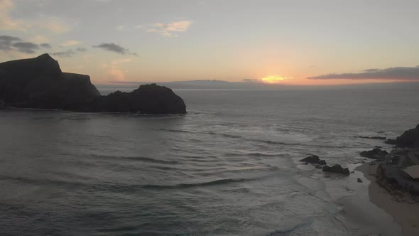 Aerial panoramic view of sunset over sea at Calheta beach, Portugal