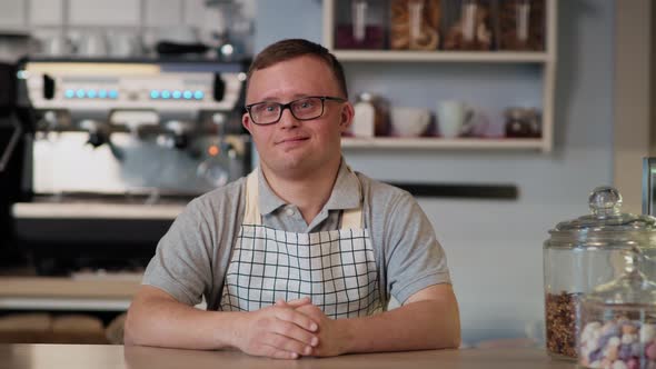 Caucasian man with down syndrome serving food to take away. Shot with RED helium camera in 8K.