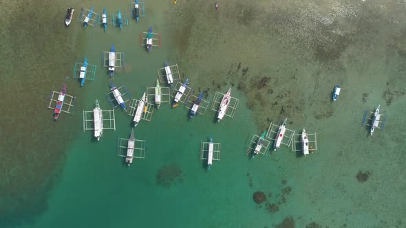 Top Drone View of a Traditional Philippine Boats on the Surface of the Azure Water in the Lagoon