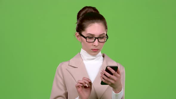 Girl Looks at the Phone and Is Surprised at What She Saw. Green Screen. Slow Motion