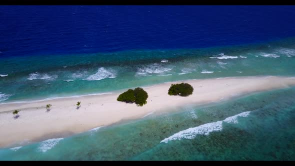 Aerial landscape of paradise tourist beach lifestyle by shallow sea with white sandy background of a