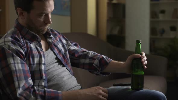 Wasted Guy Sitting on Couch, Drinking Beer, Alcoholism, Psychological Problems