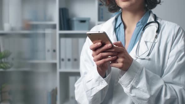 Woman Doctor Works Using Mobile At Consultation. Online Consultation. Unrecognizable Doctor