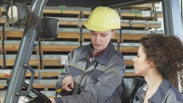 Female Forklift Operator Talking To Her Colleague While Working 1080p