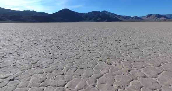 Flying low over cracked desert Racetrack Playa in Death Valley NP