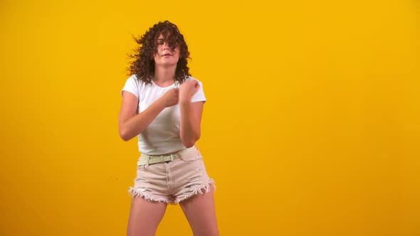 Girl Dancing on a Yellow Background