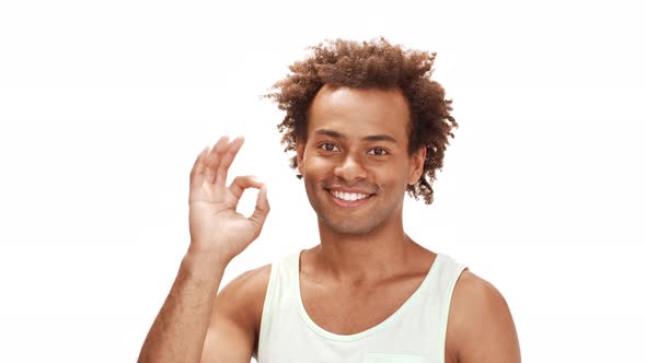 African Man Smiling Showing Okay Nodding Over White Background