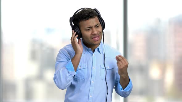 Cheerful Man Listening To Music with Headphones.