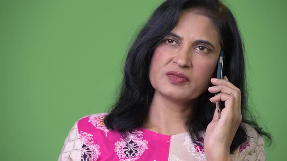 Mature Beautiful Indian Woman Thinking While Talking on the Phone