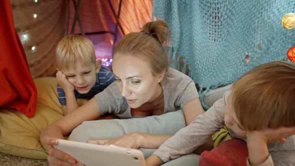 Mom Reading Fairytale on Digital Tablet to Kids