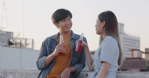 Young Asian couple hanging out on the rooftop together.