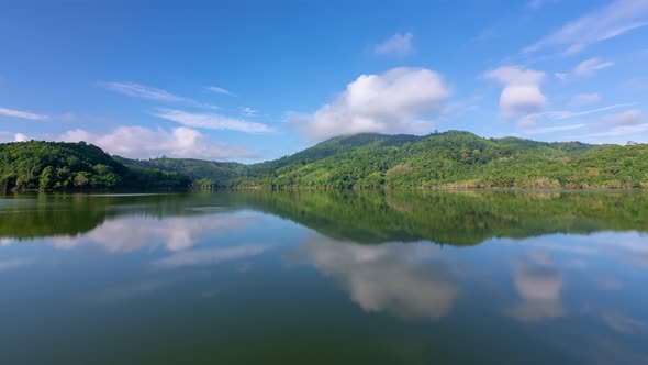 Beautiful reflection of clouds in water surface over lake or pond with Mountain tropical forest