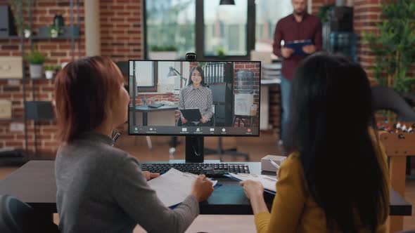 Team of Asian Women Meeting with Candidate on Video Conference Call