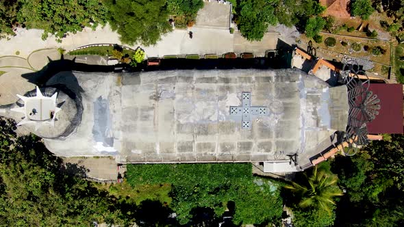 Chicken church of Magelang with green forest around, aerial top down view