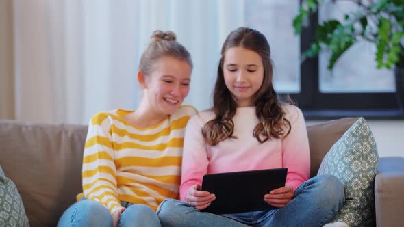 Teenage Girls with Tablet Pc Having Video Chat