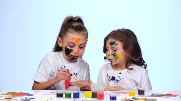 Children Paint Paints on the Palms of Their Hands. White Background. Slow Motion