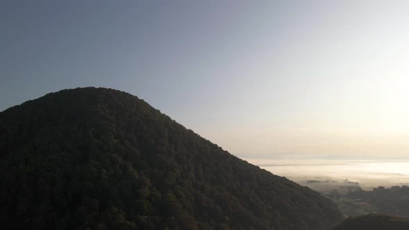 Hill at the edge of Ukrainian flatlands covered in forest. Drone