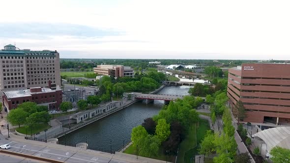 A drone shot captures footage flying north over Saginaw Street and the Flint River in Flint, Michiga