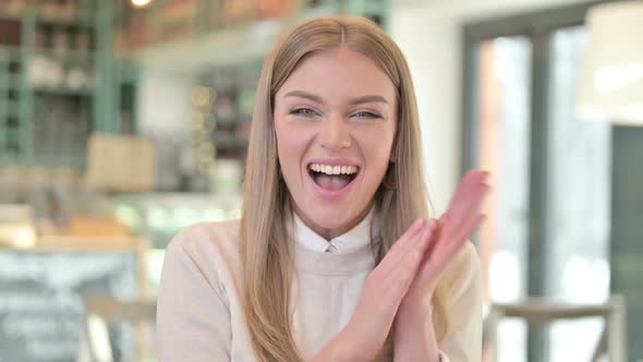 Portrait of Excited Young Woman Clapping Cheering