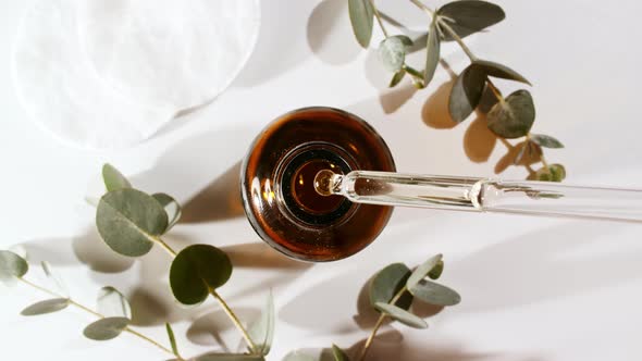Oil Drips From Pipette Into Bottle alt
