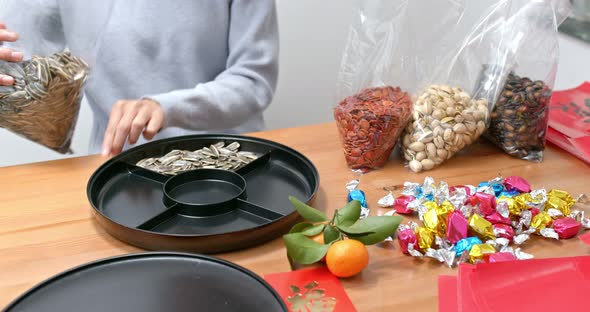 Woman fill with chinese new year snack tray