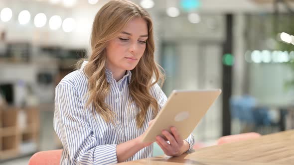 Serious Businesswoman Using Tablet in Office 