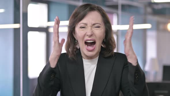 Portrait of Middle Aged Businesswoman Shouting and Screaming with Anger