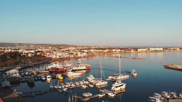 Cyprus Harbor Marina Bay with Ships Sailing from Sea and Boats and Yachts Parked Floating Near Pier