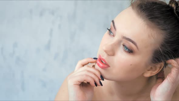 Fashion Young Woman with Beautiful Skin Posing in Studio