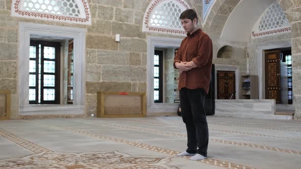 Man Standing In Prayer On Mosque