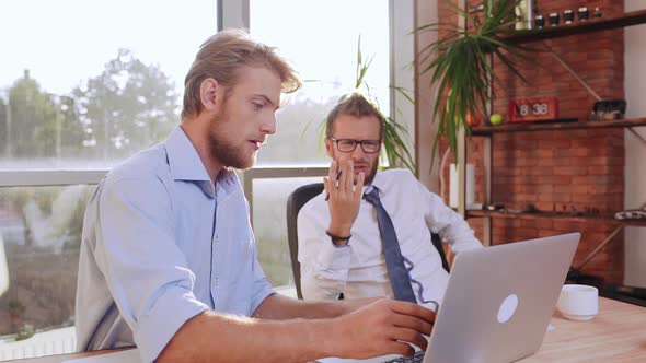 Succesful Caucasian Bearded Male Wearing Glasses Tie and White Shirt Discontentedly Discussing