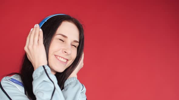 Happy Young Girl in Sportswear Listening To Music