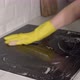 Housewife in Yellow Gloves Washes Spraying and Wipes Electric Stove at Kitchen - VideoHive Item for Sale