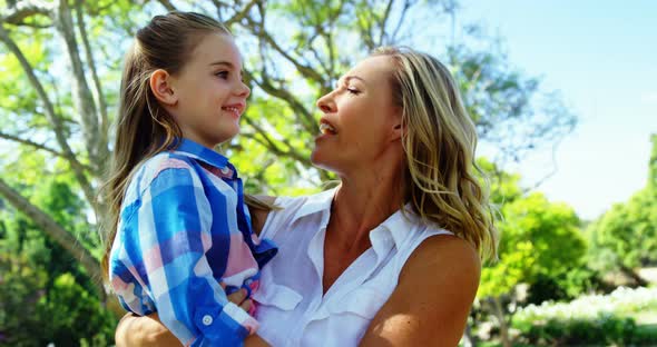 Mother and daughter embracing each other in park 4k