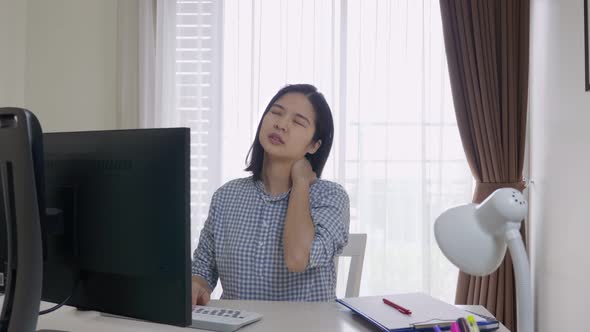 Asian woman having neck, shoulder or back pain. Office syndrome concept