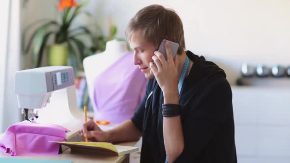 Fashion Designer Calling on Smartphone at Studio