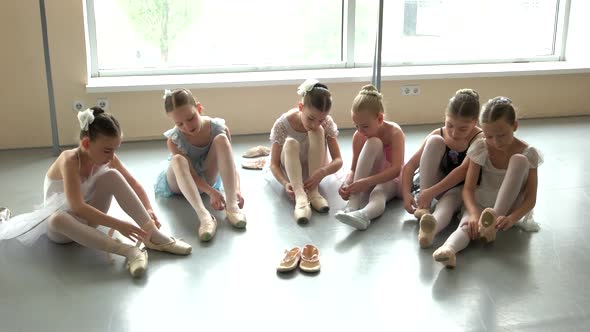 Kids Ballet Dancers Putting on Pointeshoes