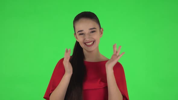 Portrait of Pretty Young Woman Is Clapping Her Hands with Wow Happy Joy . Green Screen