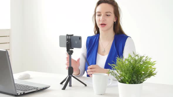 Concept of Blogging and Video Broadcasts. Young Female Blogger Recording Video or Broadcast Live on